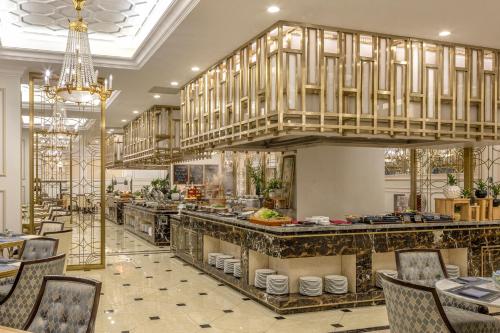 a restaurant with a large kitchen with tables and chairs at Meliá Vinpearl Phu Ly in Phủ Lý