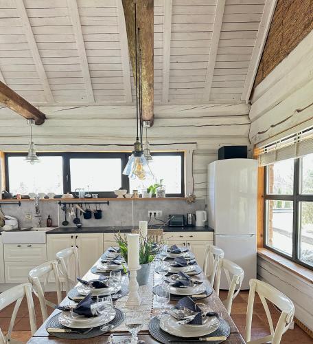 a kitchen with a long table with dishes on it at Kandimaa villa Saaremaal in Varpe