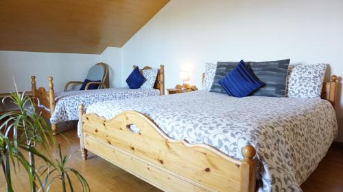 a bedroom with two beds with blue pillows at B&B La Pecora Nera in Belluno