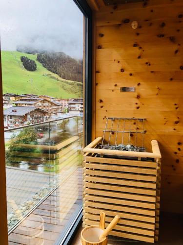 a room with a large window with a view at THOMSN Central Hotel & Appartements in Saalbach Hinterglemm