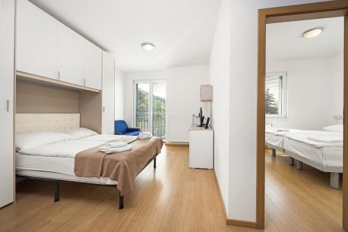 a bedroom with two beds and a mirror at Prague City Residence in Prague
