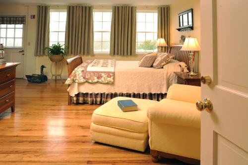 a bedroom with a bed and a chair at Newagen Seaside Inn in Southport