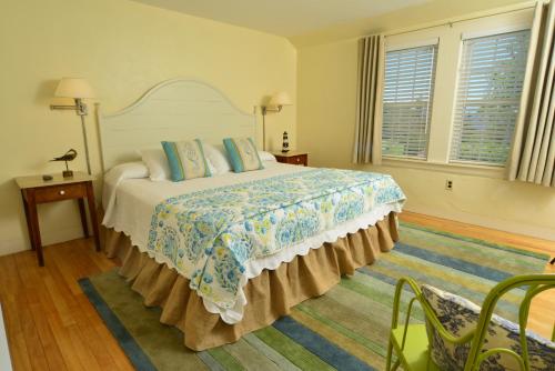 a bedroom with a large bed in a room with windows at Newagen Seaside Inn in Southport