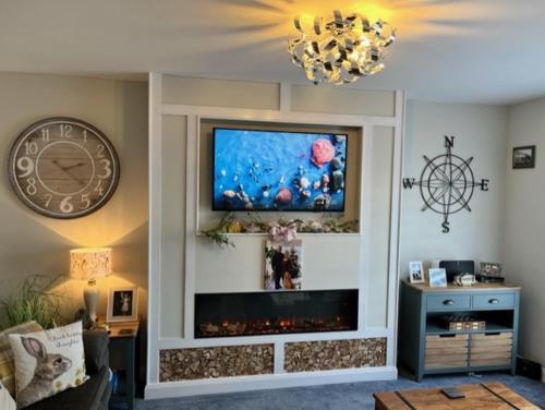 a living room with a flat screen tv on a wall at Number 14 in Downpatrick