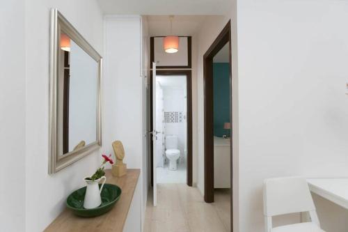 a bathroom with a sink and a mirror and a toilet at In the heart of the city in Heraklio