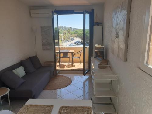 - un salon avec un canapé et une vue sur la plage dans l'établissement 3 pièces face mer et St-Tropez, à Cogolin