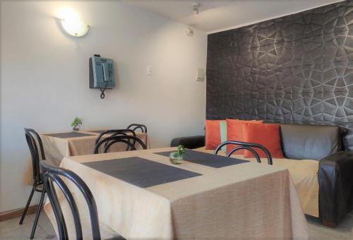 a living room with two tables and a couch at Hostal valle de la luna in Antofagasta