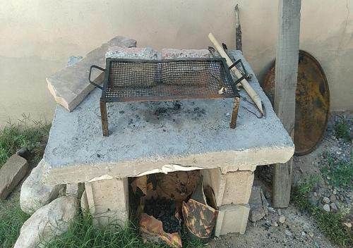 a bench sitting on top of a stone fireplace at Hospedaje el Abuelo in Humahuaca