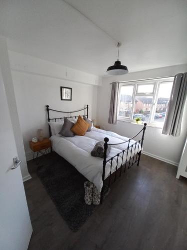 una camera da letto con un letto in una stanza con finestre di Derby City Apartment with free parking a Derby
