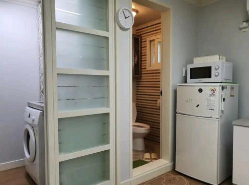 a kitchen with a refrigerator and a microwave at Cozy Place near Kyeongbuk university in Daegu