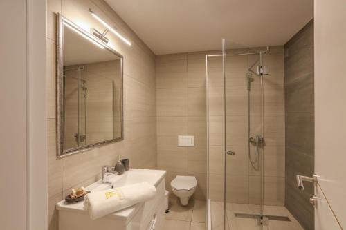 a bathroom with a shower and a sink and a toilet at Apartmani Freedom place in Jagodina