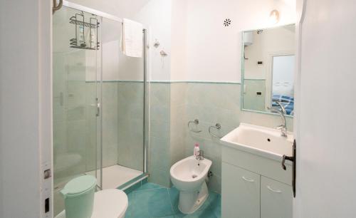 uma casa de banho com um chuveiro, um WC e um lavatório. em Divina Casa Vacanze em Sperlonga