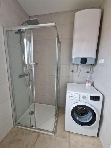 a washing machine and a washer in a bathroom at Deluxe Apartment Mila in Nin