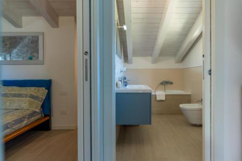a bathroom with a sink and a toilet at Alle Coccinelle, Levico Terme Ospitar in Levico Terme
