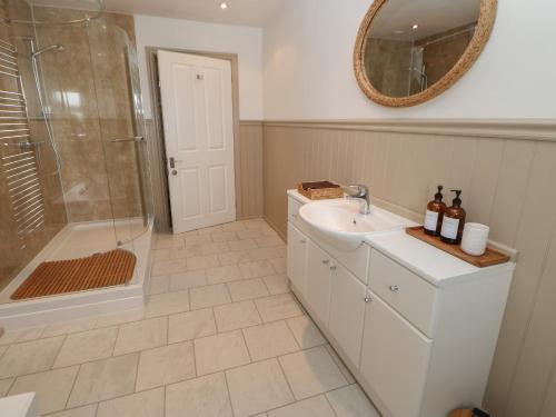 a bathroom with a sink and a shower and a mirror at Hudeway View in Barnard Castle