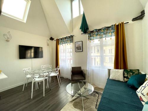 a living room with a table and a couch at Le 1731, Rouen coeur d'histoire, superbe duplex in Rouen