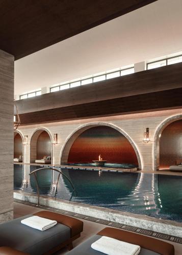 a large swimming pool in a building with a bridge at One&Only Portonovi in Herceg-Novi