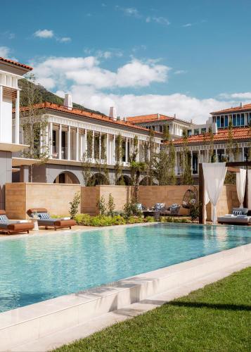 a swimming pool in front of a building at One&Only Portonovi in Herceg-Novi
