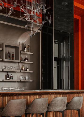 a bar with three chairs in front of a mirror at One&Only Portonovi in Herceg-Novi