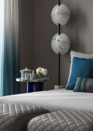 a bedroom with a bed and a table with flowers at One&Only Portonovi in Herceg-Novi