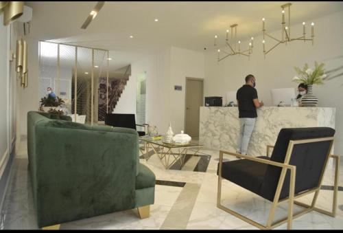 a man standing at a counter in a living room at OR HOTEL 94 in Barranquilla
