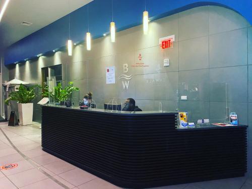 a lobby with a counter with people sitting at it at Relaxing BeachWalk Getaway Studio for 4 Guests 405B in Hallandale Beach