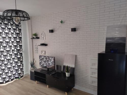 a living room with a white brick wall at Benal Isa in Benalmádena