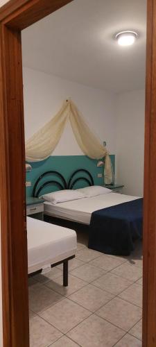 a bedroom with two beds with a tent above them at Residence Danubio in San Benedetto del Tronto