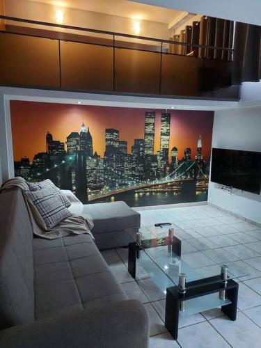 a living room with a large mural of a city at City Loft in Sparta