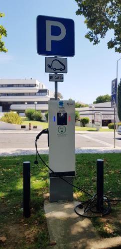 a gas pump sitting next to a street sign at AlbufeiraSun, arrive as a guest leave as a friend. in Albufeira