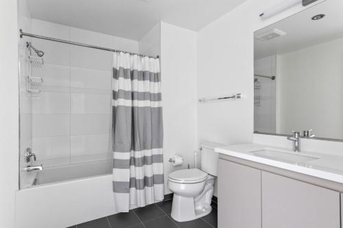 a bathroom with a toilet and a sink and a shower at Downtown 1BR w Roof Pool Gym nr the 110 LAX-734 in Los Angeles