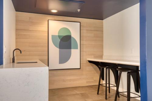 a kitchen with two bar stools and a painting on the wall at N Hollywood 1BR w Pool Gym nr shops LAX-529 in Los Angeles