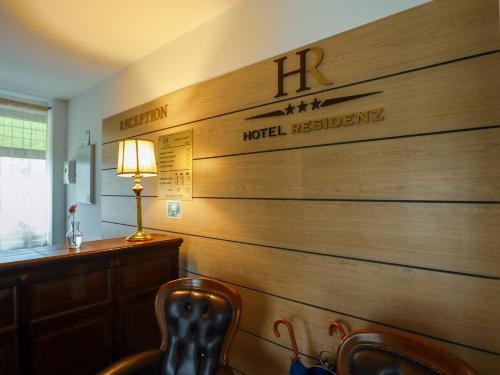 a wooden wall with a hotel registration sign on it at Hotel Residenz in Suceava