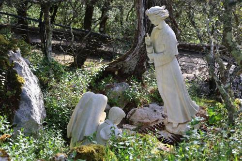 a group of statues sitting in the grass at Hotel Dom Goncalo & Spa in Fátima
