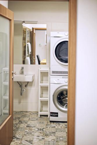 a bathroom with a washing machine and a sink at Nice accommodation in Mikulov in Mikulov