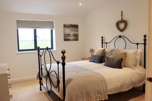 a bedroom with a bed and a mirror on the wall at Cowley Farm, Preston Bissett, Buckingham in Buckingham