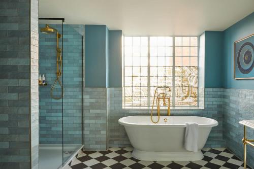 a bathroom with a bath tub and a window at Hotel Indigo - Exeter, an IHG Hotel in Exeter