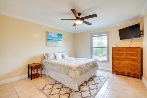 a bedroom with a bed and a ceiling fan at Lehigh Acres Vacation Rental with Screened Patio! in Lehigh Acres