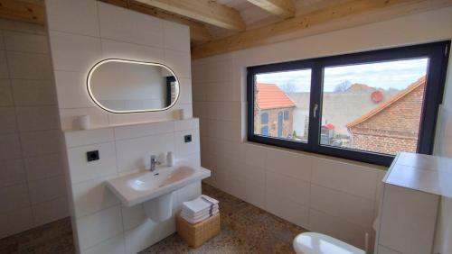 a bathroom with a sink and a window at großzügige Ferienwohnung mit weitem Ausblick in Lichtenberg