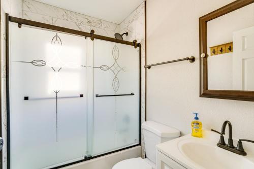 a bathroom with a shower and a toilet and a sink at Central Henderson Retreat Near Dining and Lake Mead! in Las Vegas