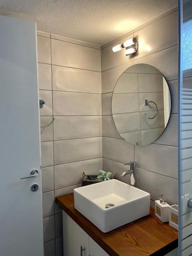 a bathroom with a white sink and a mirror at The balcony in Glossa