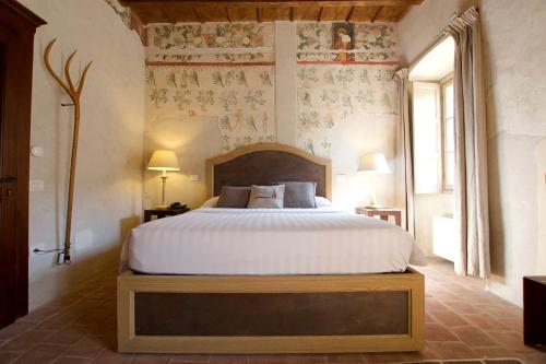 a bedroom with a large bed in a room at Hotel San Giovanni Resort in Saluzzo