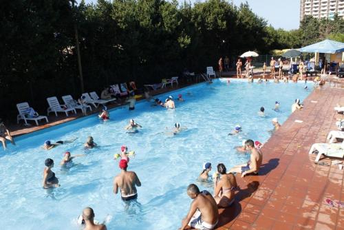a group of people swimming in a swimming pool at Camping Village Costa Verde in Porto Potenza Picena