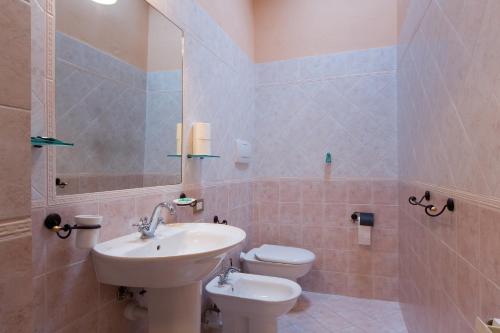 a bathroom with a sink and a toilet at Antico Borgo Poggiarello in Monteriggioni