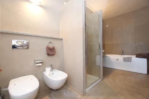 a bathroom with a shower and a toilet and a sink at Hotel San Giovanni Resort in Saluzzo