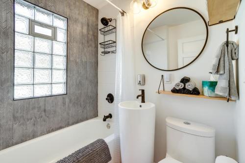 a bathroom with a white toilet and a mirror at Charming and Updated Home in Howe Neighborhood! in Minneapolis