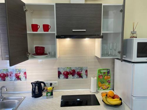 a kitchen with a sink and a white refrigerator at Luxury Room_Karavaeva in Dnipro