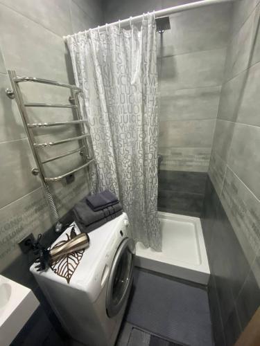 a bathroom with a toilet and a sink and a tub at Luxury Room_Karavaeva in Dnipro