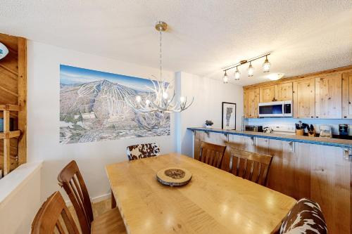 a kitchen and dining room with a wooden table at Okemo Trailside 22DL Shred Shack in Ludlow