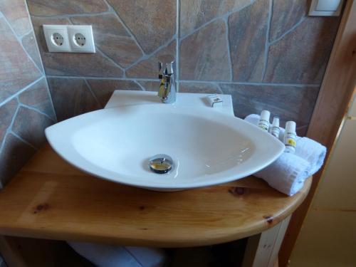 a bathroom with a white sink in a bathroom at Holzberghof in Umhausen